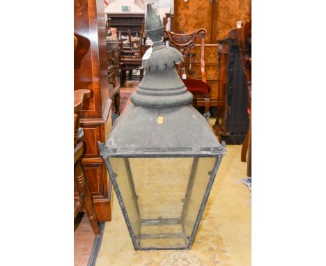 A brass and glass oil lamp with amber shade
