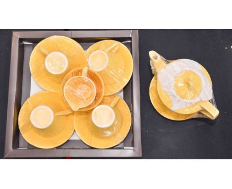 A 1940s, yellow ground, child's tea service, including four teacups, saucers, jug, basin and teapot   