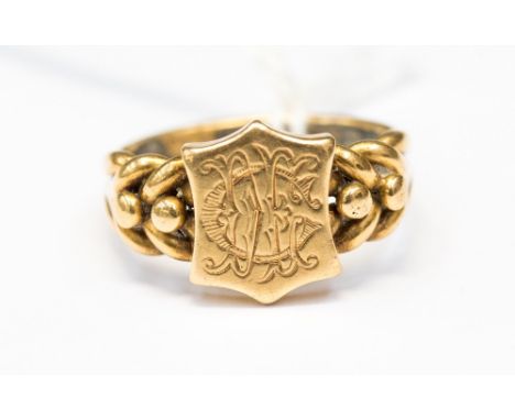 An 18ct gold signet ring monogrammed initial to shield front, approx 6.7gms