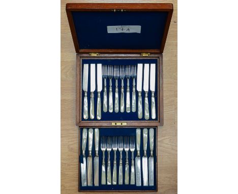 A matched set of twelve early 20th Century silver-plate  fruit knives and forks, mother-of-pearl handles with reeded collars,