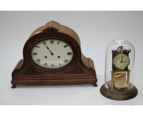 A large oak mantle clock, 8 day movement, enamel dial; together with 400 day movement mantle clock in a glass dome (2) 