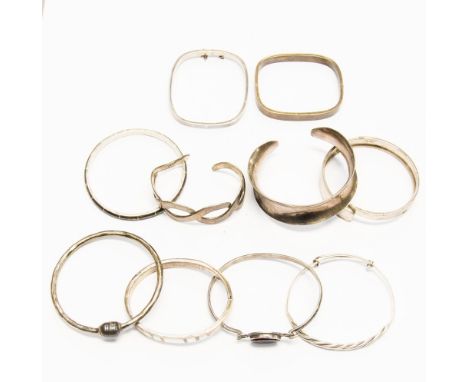 Ten various silver bangles, some set with mother of pearl and stone decoration, 6.46 ozt/200.9 grams approx 