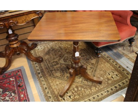 A George III mahogany tilt-top tripod table, circa 1815, raised on a turned column and standing on three sabre legs