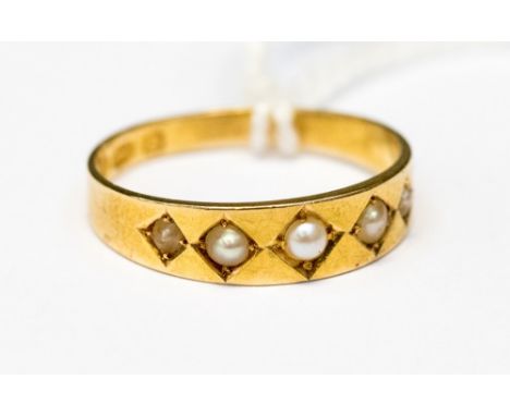 A Victorian 18ct gold five seed pearl set band ring, size M