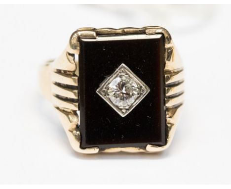 A diamond and black onyx rose gold ring marked 10K, the carre set round brilliant cut diamond measuring approximately 0.33 ca