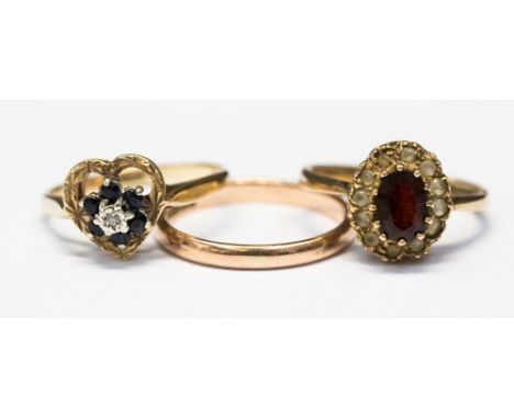 A 9ct rose gold wedding band approximately 1.8 grams, garnet 9ct gold ring and a diamond and sapphire 9ct gold ring, gross we