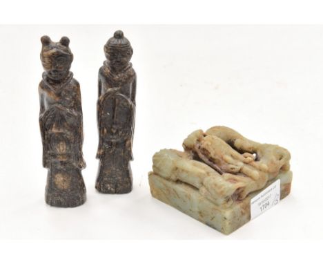 Two carved stone figures, with a carved jade seal