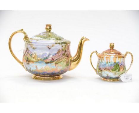 After Daisy Makeig-Jones for Wedgwood, a modern teapot and sucrier and cover, decorated in the round with lakeside Oriental l