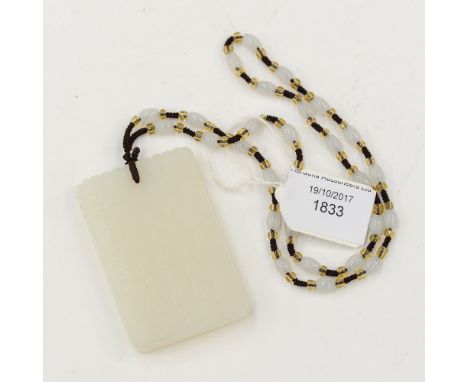 A Chinese jade type pendant slab, script to one side, a landscape to the other, 7cm long