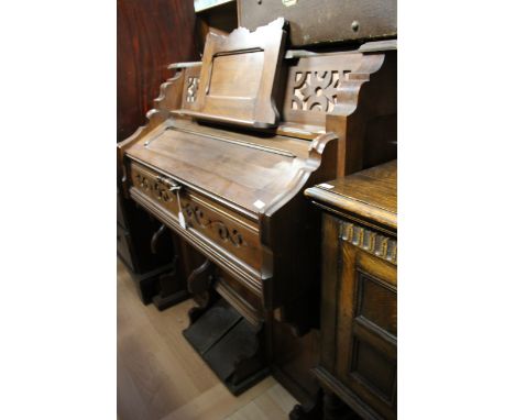 A 20th Century harmonium, having five octaves, the base with two pump pedals