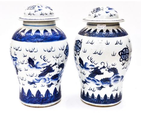 A pair of Chinese blue and white vases and covers, drilled for lamp bases (2)