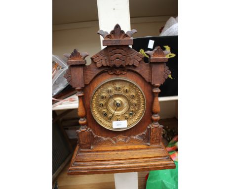 An eight day movement Tivoli mantel strike Ansonia Clock Co, New York, USA encased in black forest style case 