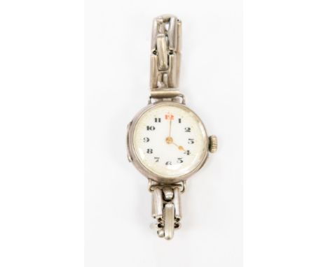 A ladies silver watch on expander bracelet with enamel dial, black numerals and gold coloured hands, circa 1930 