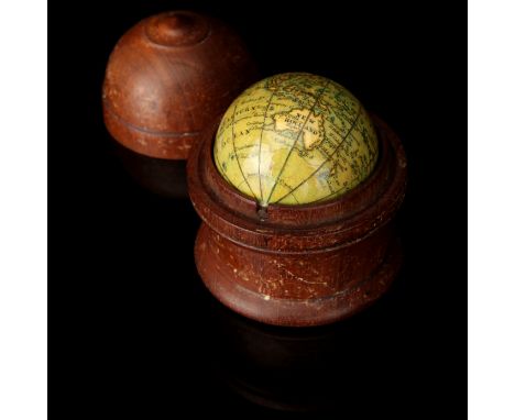 A Newton & Son's New Terrestrial Pocket Globe, in turned wood case, domed lid with raised knob, with 12 hand-colored copper-e