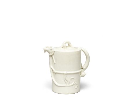 A WHITE-GLAZED 'CHILONG' EWER AND COVERKangxiCrisply potted of cylindrical form and applied around the straight walls of the 