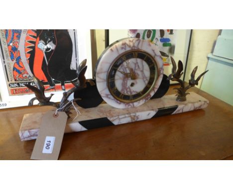 An Art Deco rouge and veined marble mantel clock with gilt metal bird form mounts