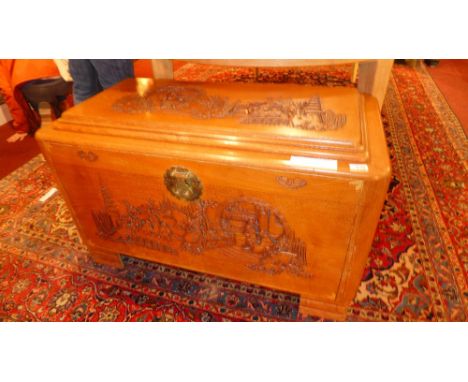 An Oriental profusely carved camphorwood trunk 