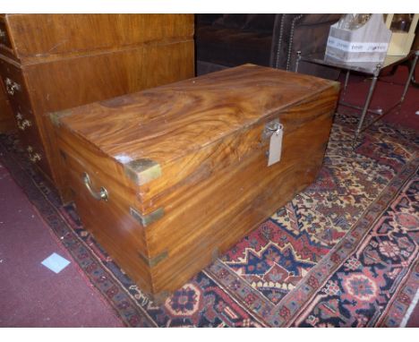 A 19th Century camphorwood and brass bound trunk with brass twin handles