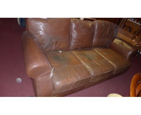 A contemporary designer three seater sofa upholstered in brown leather