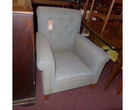 A pair of early 20th century armchairs upholstered in green velour fabric with repeating flowerhead designs, having button ba