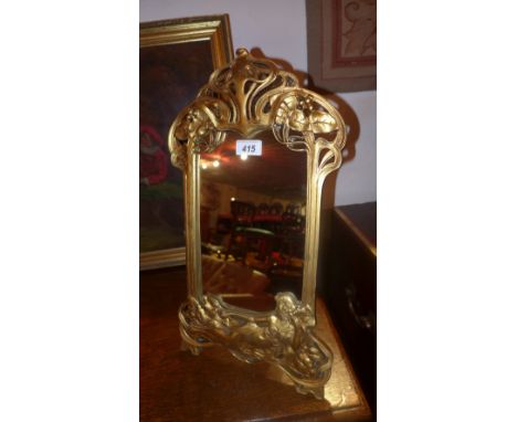 An Art Nouveau style carved and gold painted easel mirror  