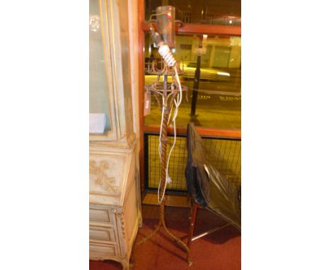 An early 20th century wrought iron standard lamp 
