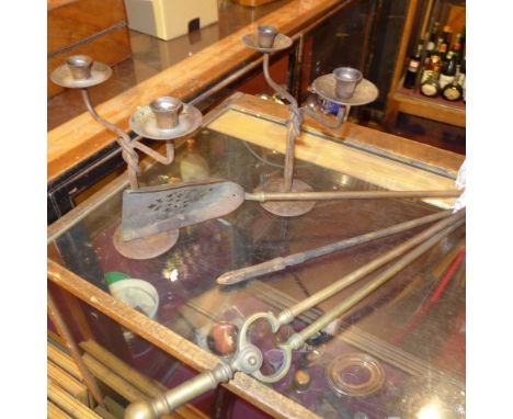 A set of three 19th century fireside tools together with a pair of wrought iron two branch candelabra 