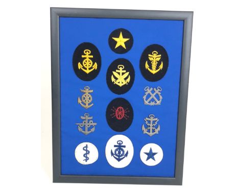 German Third Reich WW2  Kriegsmarine Trade Badges.  A selection of 12 cloth and metal trade badges. Mounted onto board for di