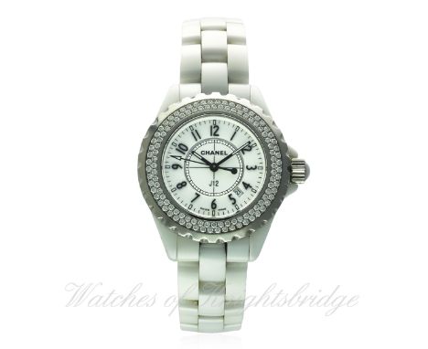 A MID SIZE WHITE CERAMIC CHANEL J12 BRACELET WATCH DATED 2005, WITH BOX & PAPERS
D: White dial with raised Arabic numerals, d