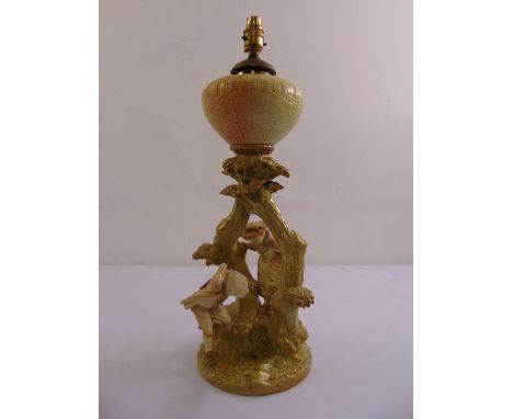 A Royal Worcester porcelain oil lamp with figurines of a boy, girl and frog under a tree, signed to the base Hadley