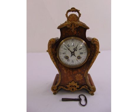 A French mantle clock, circular white enamel dial with Roman numerals, to include pendulum and key
