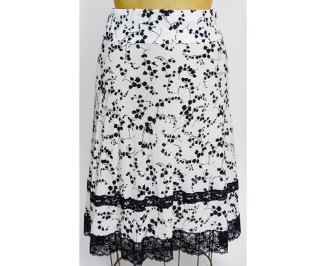 From a Palm Beach Socialite, A Dolce & Gabbana Print Silk Skirt. Black Lace Trim. Labeled: Dolce & Gabbana Made In Italy. Siz