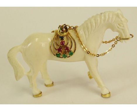 Carved Ivory Horse Pendant with 14 Karat Yellow Gold Saddle with Emerald and Ruby Accents. Signed 14K 585. Good Condition. Me