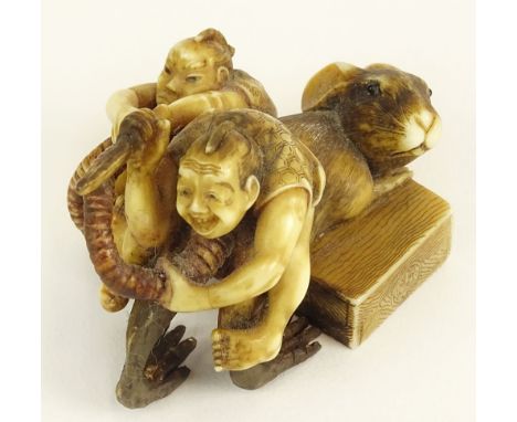 Well Done Antique Japanese Ivory Netsuke. Depicts Miniature Figures Cutting The Tail of a Rat. Two (2) Character Signature on