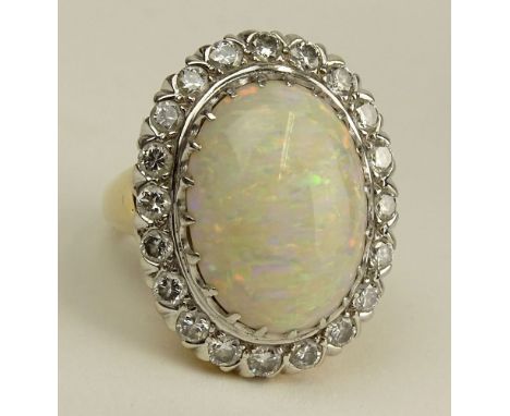 Lady's Vintage White Opal, Round Cut Diamond and 14 Karat Yellow and White Gold Ring. Opal Measures 20mm x 14mm. Diamonds F-G