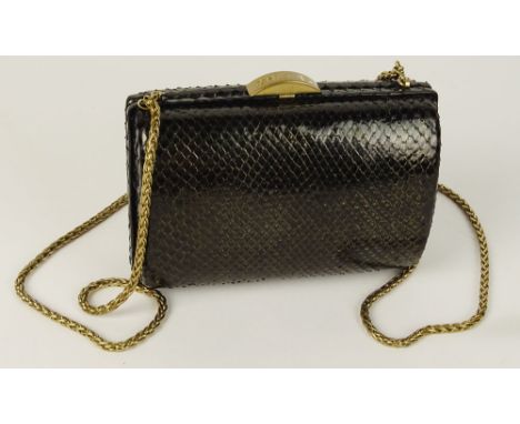 From a Palm Beach Socialite, A Chanel Black Snakeskin Clutch Evening Bag. Goldtone Chain and Signature Closure. Gold Lame Int