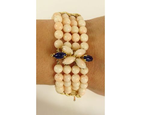 Lady's Vintage Angelskin Coral and 14 Karat Yellow Gold Four Strand Bead Bracelet, Clasp with Lapis Lazuli accents. Unsigned.