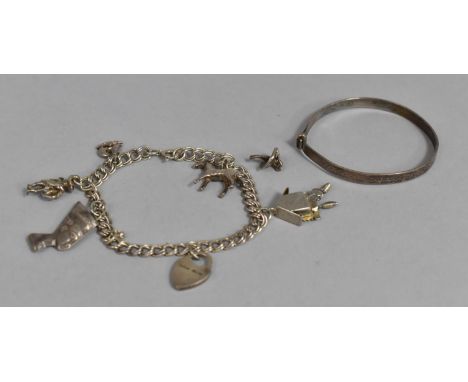 A Silver Charm Bracelet with various Charms to include Horse, Nefertiti, Cuckoo Clock etc together with A Silver Christening 