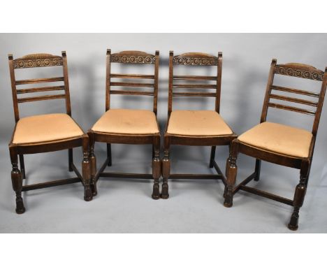 A Set of Four Mid 20th Century Oak Framed Ladder Back Dining Chairs with Carved Top Rails 