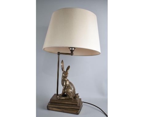 A Modern gilt Decorated Metal Novelty Table Lamp in the Form of Rabbit Sat Upon Three Books, With Shade 
