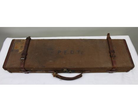An early 20th century canvas covered single gun case, baize lined, lid monogrammed P.F.D.T., 79cm wide