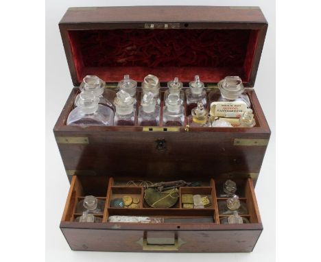 A 19th century campaign apothecary casket, brass banded mahogany, the hinged lid opens to reveal twelve assorted bottles with