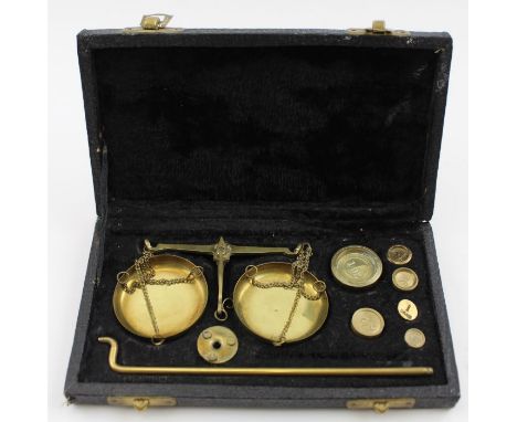 A cased set of brass beam balance gold scales, with weights, in fitted case