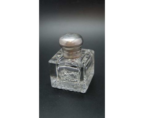 An early 20th century silver mounted facet glass desk inkwell, with hobnail base, the hinged silver cover monogrammed, Birmin