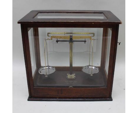 Griffin &amp; George, A brass laboratory balance scale, in glazed mahogany display cabinet, the cabinet 46cm x 43cm