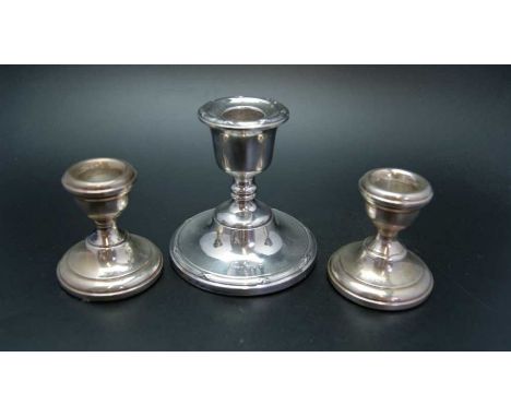 A.T.Cannon, a pair of silver squat form candlesticks, Birmingham 1967, 6cm high, together with a single silver candlestick, B