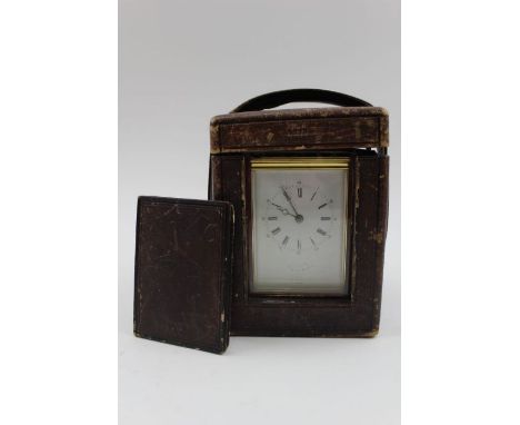 A 19th century French brass repeater carriage clock, the gilt brass frame with five bevel glass panels and hinged handle, the