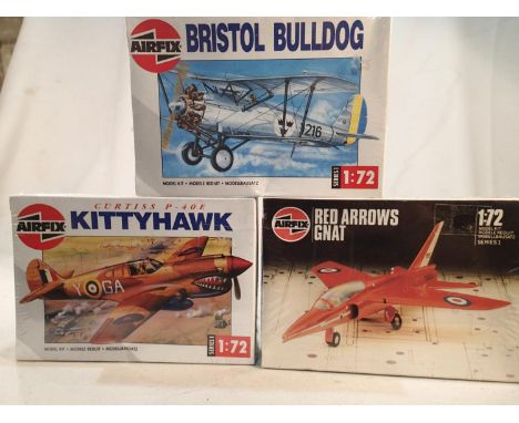 Three Airfix aircraft kits, 1/72 scale, Kittyhawk, Red Arrows Gnat, and Bristol Bulldog, factory sealed, wear to boxes. UK P&