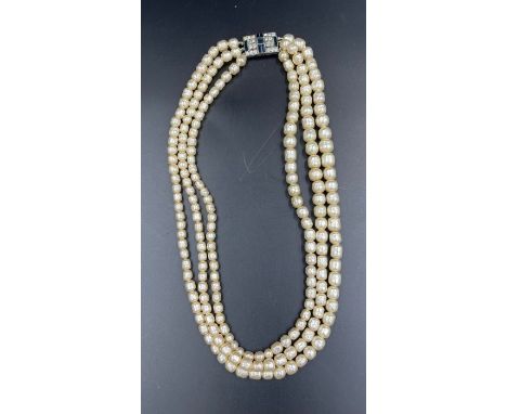 A Three strand pearl necklace with silver clasp.