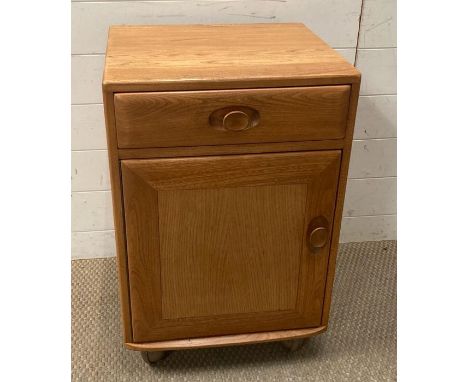 A teak Ercol dining room side cabinet on castors (W47cm D43cm H68cm)